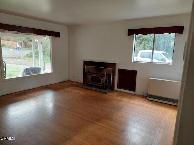 unfurnished living room with wood finished floors