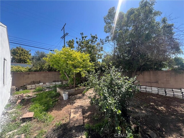 view of yard featuring a fenced backyard and a vegetable garden