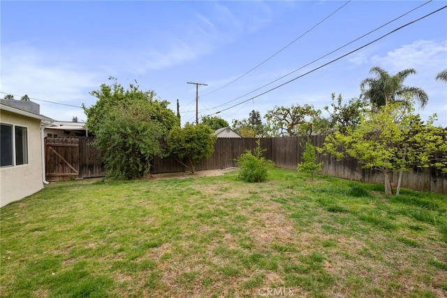 view of yard with a fenced backyard