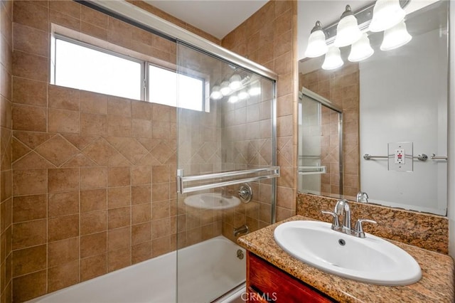 full bathroom featuring vanity and combined bath / shower with glass door
