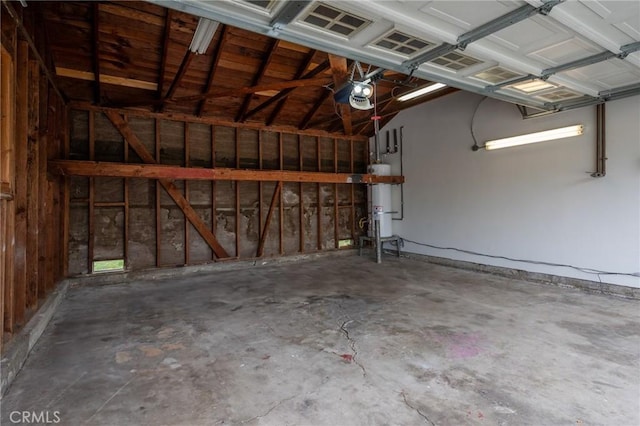 garage with water heater and a garage door opener