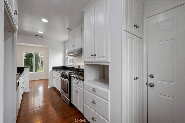 kitchen featuring dark wood-style flooring, stainless steel range with gas cooktop, under cabinet range hood, recessed lighting, and white cabinetry