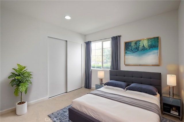 carpeted bedroom featuring a closet, baseboards, and recessed lighting