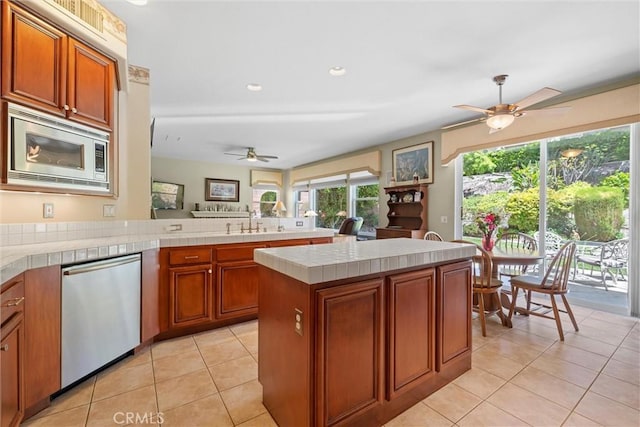 28311 Harvest View Ln, Lake Forest, CA 92679 - kitchen featuring a ceiling fan, stainless steel appliances, light tile patterned flooring, brown cabinets, and recessed lighting