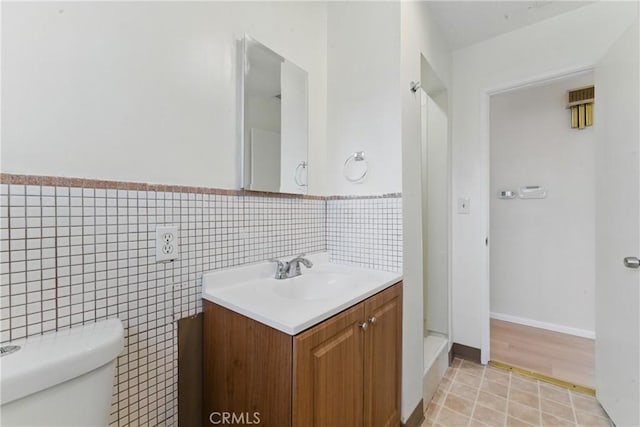 1114 Stovall Ave, La Puente, CA 91745 - bathroom featuring tile walls, vanity, and toilet