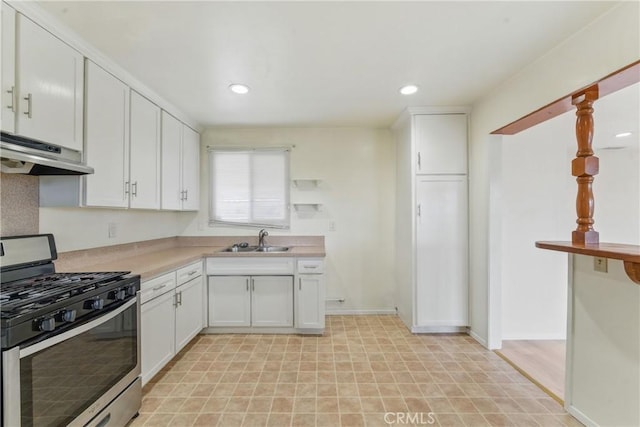 1114 Stovall Ave, La Puente, CA 91745 - kitchen with stainless steel range with gas cooktop, under cabinet range hood, a sink, and white cabinets