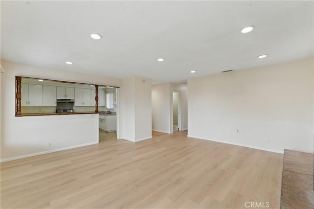 1114 Stovall Ave, La Puente, CA 91745 - unfurnished living room with recessed lighting, light wood-type flooring, visible vents, and baseboards