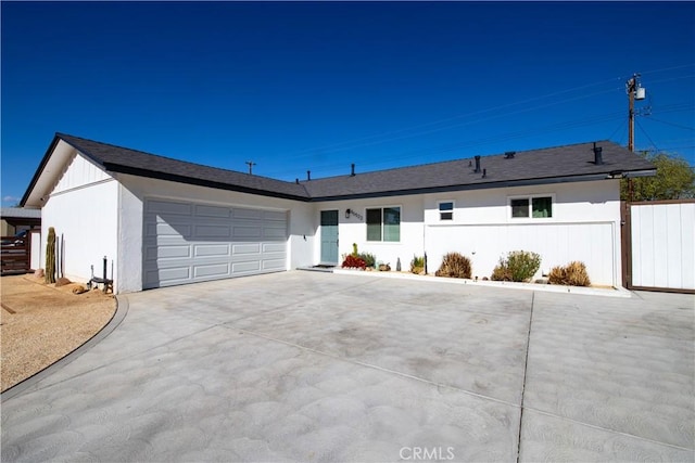 45522 Andale Ave, Lancaster, CA 93535 - ranch-style house featuring a garage, driveway, fence, and stucco siding
