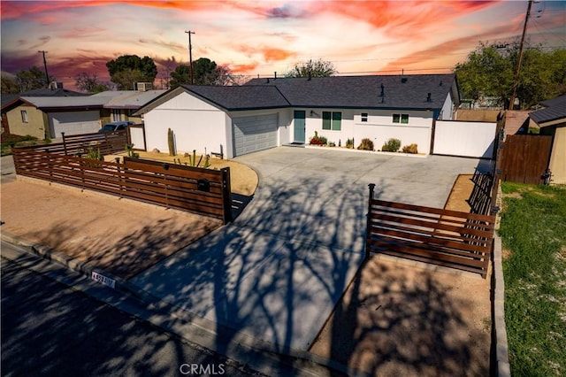 45522 Andale Ave, Lancaster, CA 93535 - ranch-style home with a fenced front yard, driveway, stucco siding, a gate, and a garage