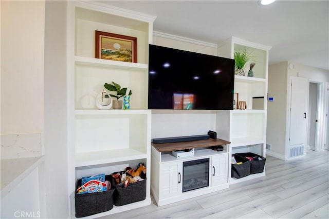45522 Andale Ave, Lancaster, CA 93535 - living room featuring wood finished floors, built in shelves, baseboards, and crown molding