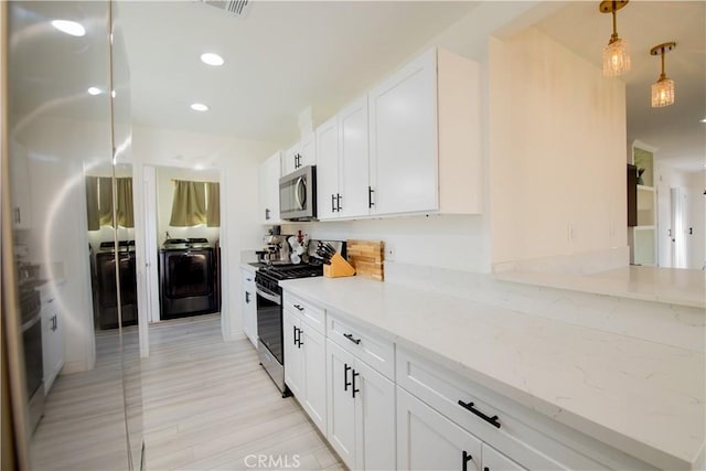 45522 Andale Ave, Lancaster, CA 93535 - kitchen featuring washer / dryer, stainless steel appliances, white cabinetry, light stone countertops, and recessed lighting