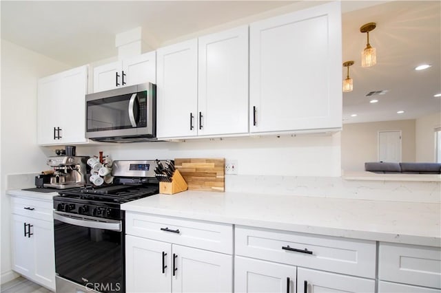45522 Andale Ave, Lancaster, CA 93535 - kitchen featuring appliances with stainless steel finishes, light stone counters, white cabinets, recessed lighting, and decorative light fixtures