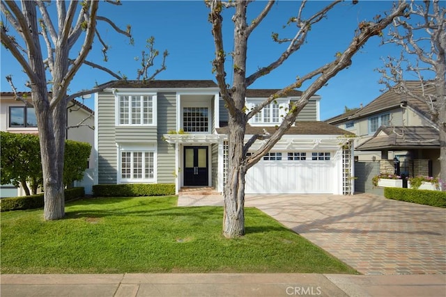 736 Harbor Island Dr, Newport Beach, CA 92660 - traditional-style house featuring an attached garage, a front lawn, and decorative driveway