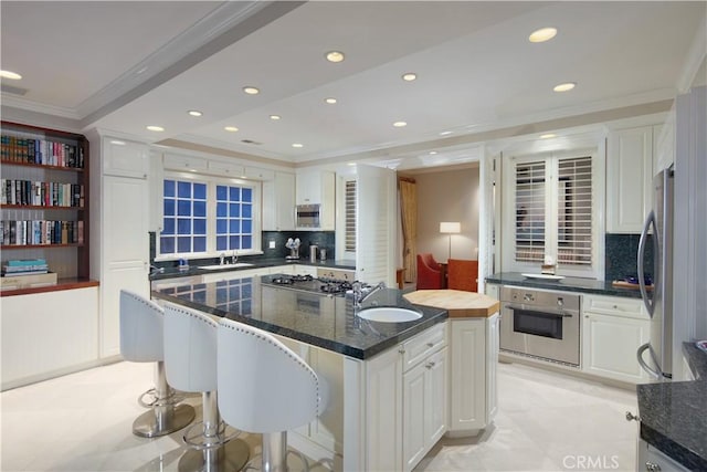 736 Harbor Island Dr, Newport Beach, CA 92660 - kitchen with crown molding, a sink, white cabinetry, and stainless steel appliances