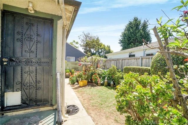 doorway to property featuring fence