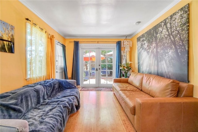 living room with crown molding, french doors, and wood finished floors