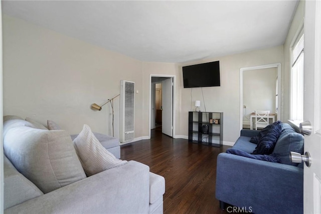 living area featuring baseboards and wood finished floors