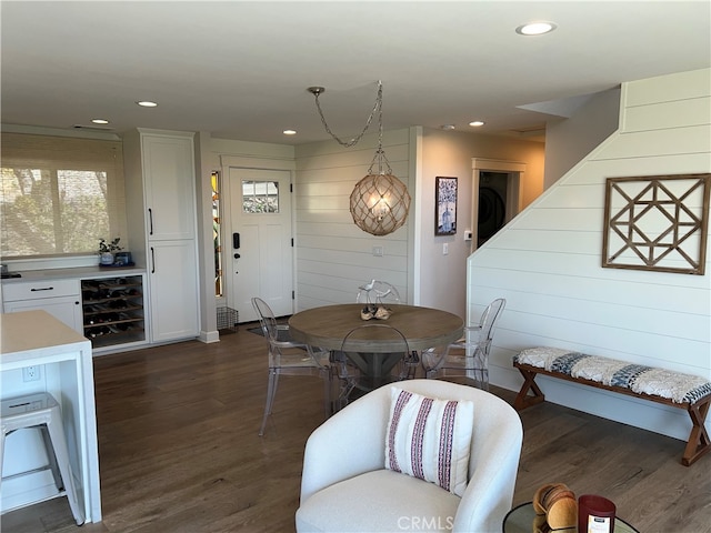 dining space with recessed lighting, dark wood finished floors, and beverage cooler