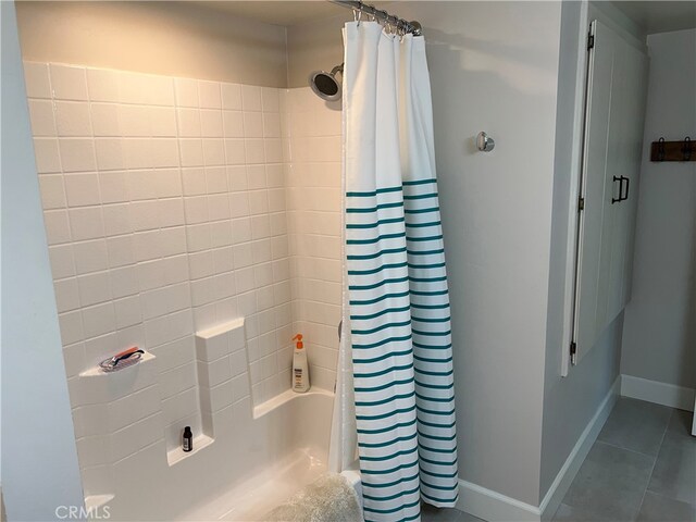 full bath with tile patterned floors and baseboards