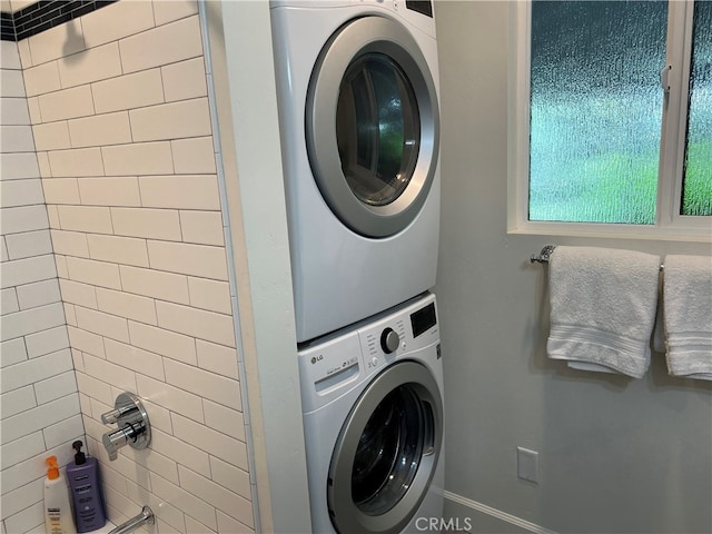 laundry room featuring laundry area and stacked washer / dryer