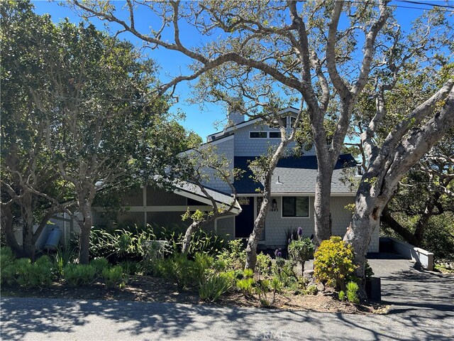 view of front of house featuring roof with shingles