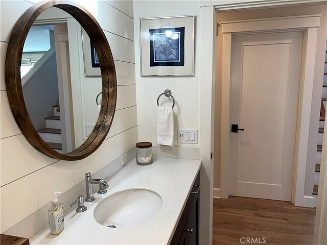 bathroom with vanity and wood finished floors