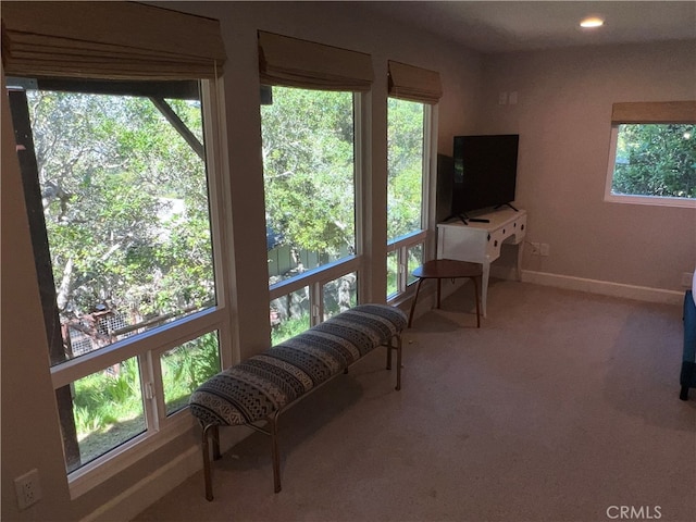 carpeted living room with recessed lighting and baseboards