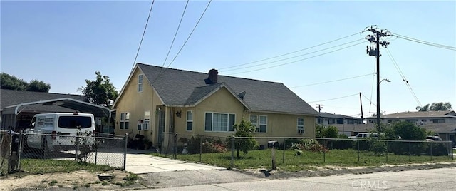 view of front facade with a fenced front yard, stucco siding, a chimney, and roof with shingles