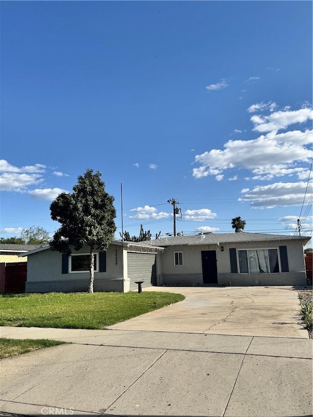 26659 6th St, Highland, CA 92346 - ranch-style home with concrete driveway, stucco siding, and a front yard