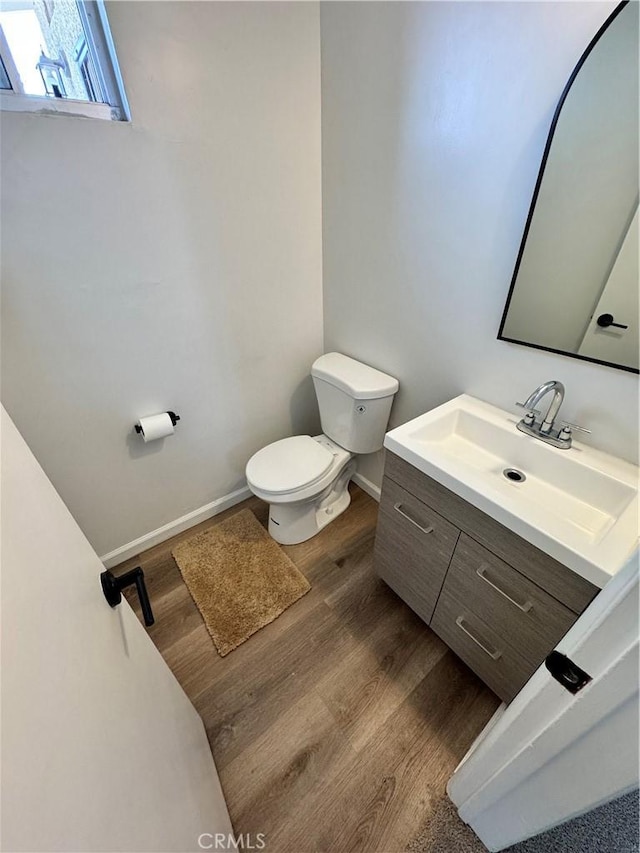 26659 6th St, Highland, CA 92346 - bathroom featuring toilet, wood finished floors, vanity, and baseboards
