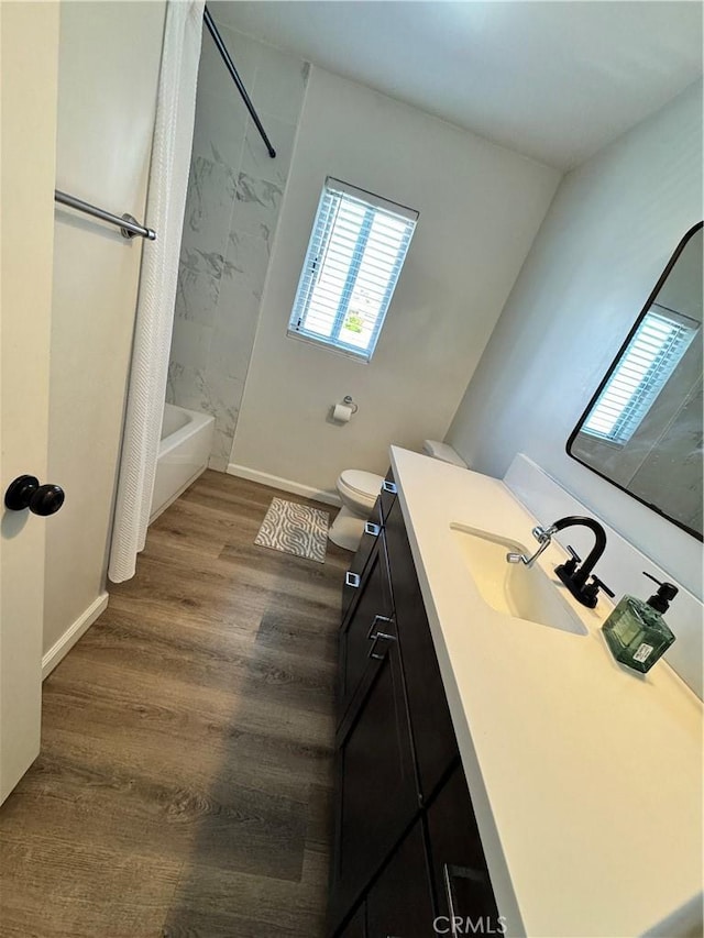 26659 6th St, Highland, CA 92346 - full bath featuring vanity, washtub / shower combination, baseboards, wood finished floors, and toilet