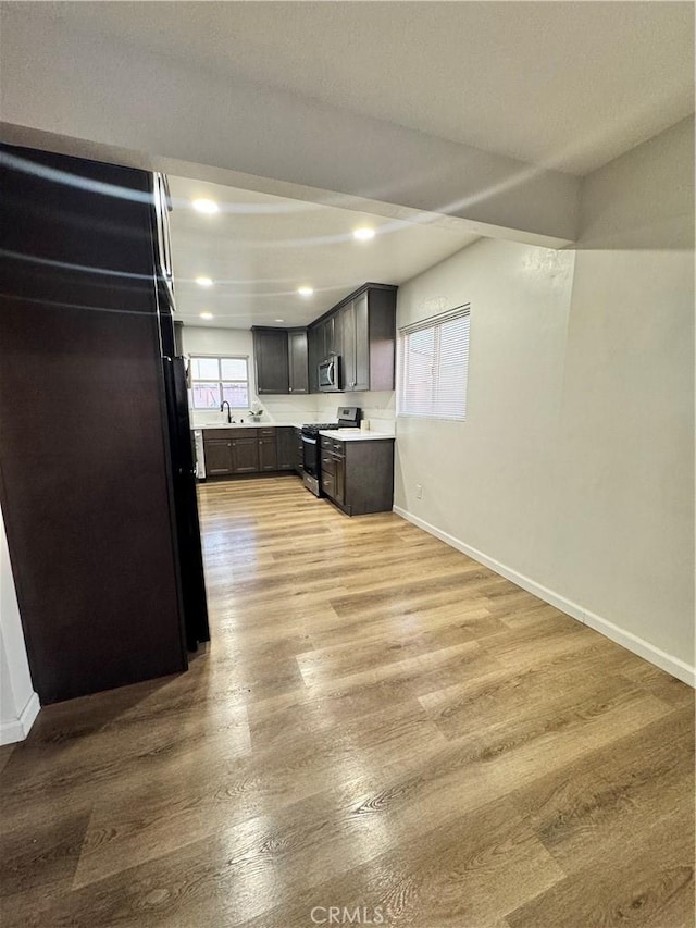 26659 6th St, Highland, CA 92346 - kitchen featuring appliances with stainless steel finishes, light wood finished floors, baseboards, light countertops, and recessed lighting