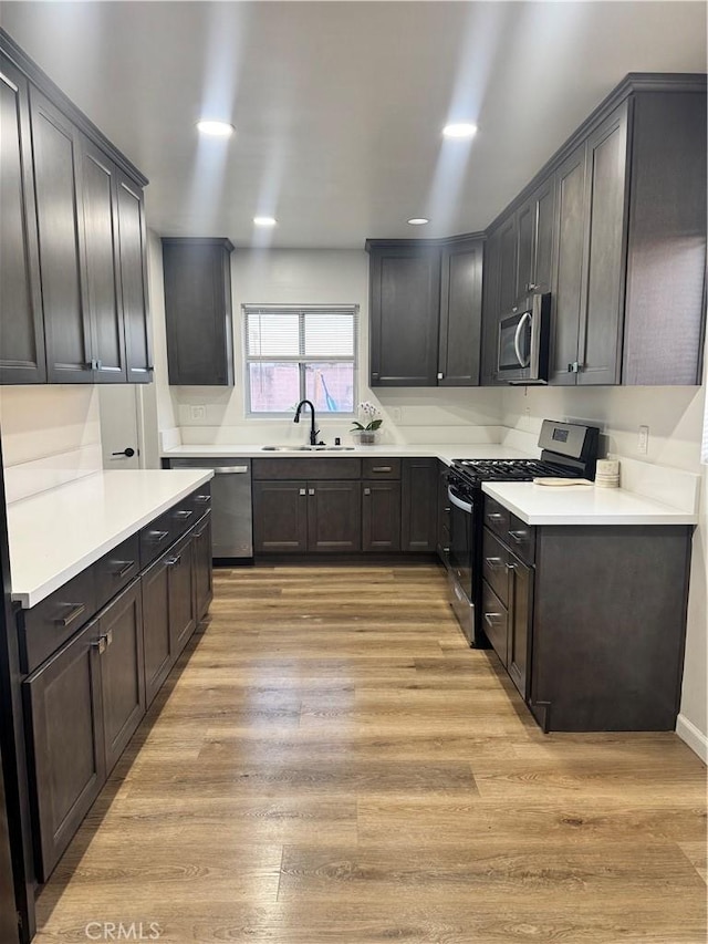 26659 6th St, Highland, CA 92346 - kitchen featuring stainless steel appliances, a sink, light wood-style floors, light countertops, and recessed lighting