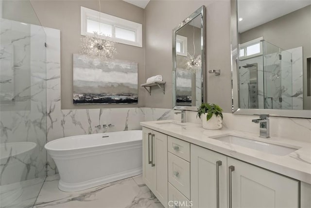 625 Calle Miguel, San Clemente, CA 92672 - bathroom with marble finish flooring, a freestanding tub, a marble finish shower, double vanity, and a chandelier