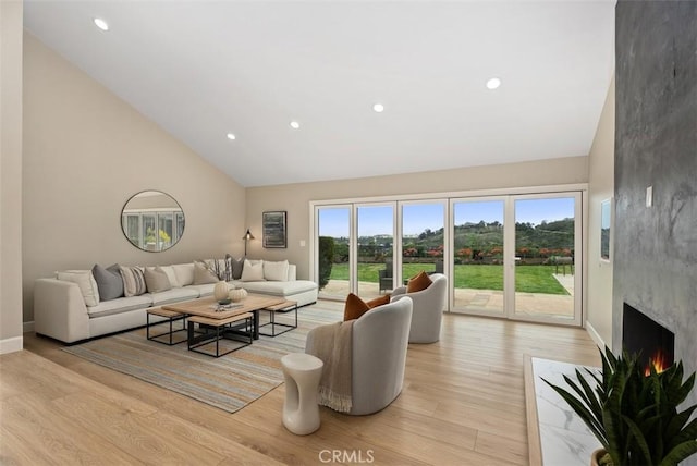 625 Calle Miguel, San Clemente, CA 92672 - living room featuring high vaulted ceiling, light wood-style floors, a premium fireplace, and recessed lighting