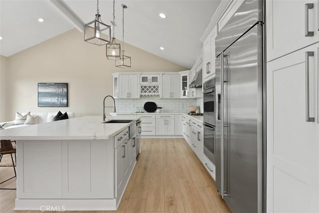 625 Calle Miguel, San Clemente, CA 92672 - kitchen with stainless steel built in refrigerator, white cabinetry, decorative backsplash, glass insert cabinets, and recessed lighting