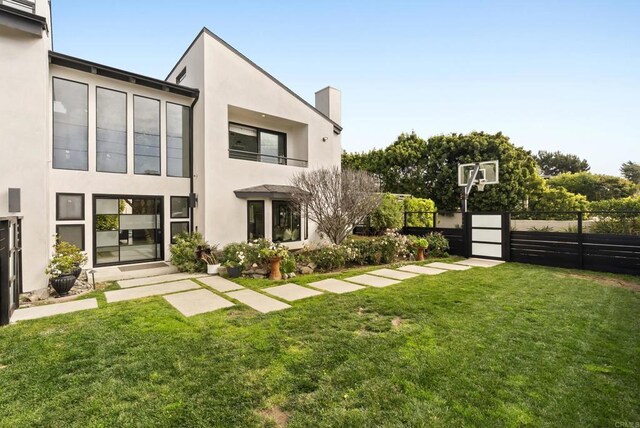 314 S Nardo Ave, Solana Beach, CA 92075 - back of property with fence, a balcony, stucco siding, a chimney, and a lawn