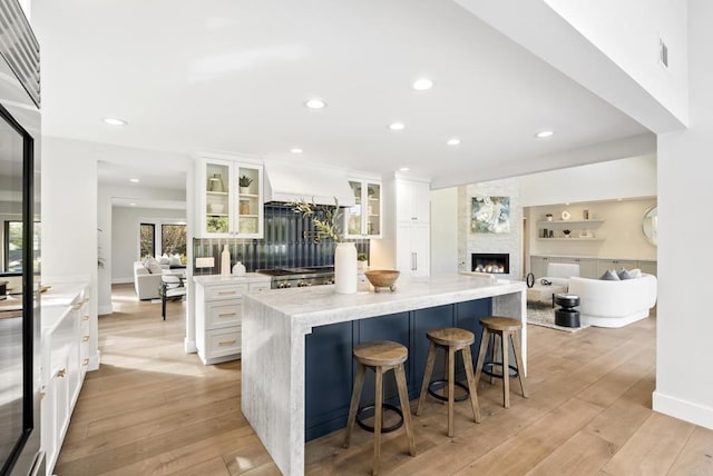 314 S Nardo Ave, Solana Beach, CA 92075 - kitchen featuring a large island, custom exhaust hood, light wood-style flooring, and white cabinetry
