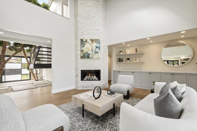 314 S Nardo Ave, Solana Beach, CA 92075 - living room featuring light wood finished floors, a high ceiling, a stone fireplace, and recessed lighting