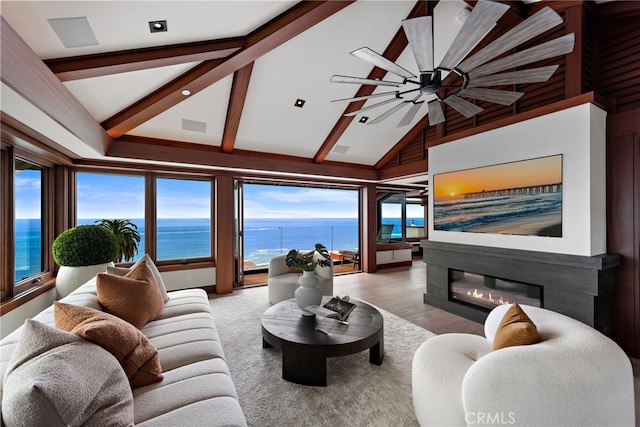 living room with high vaulted ceiling, beamed ceiling, a ceiling fan, and a wealth of natural light