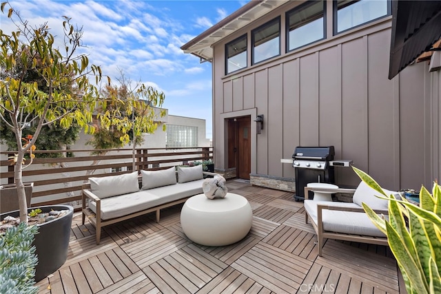 wooden terrace featuring area for grilling and outdoor lounge area