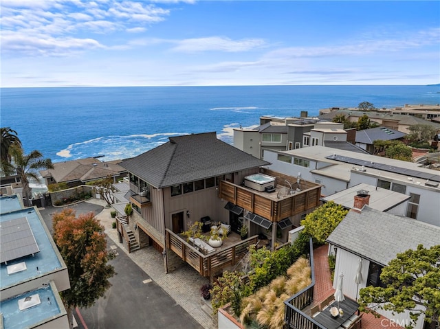 birds eye view of property with a water view and a residential view