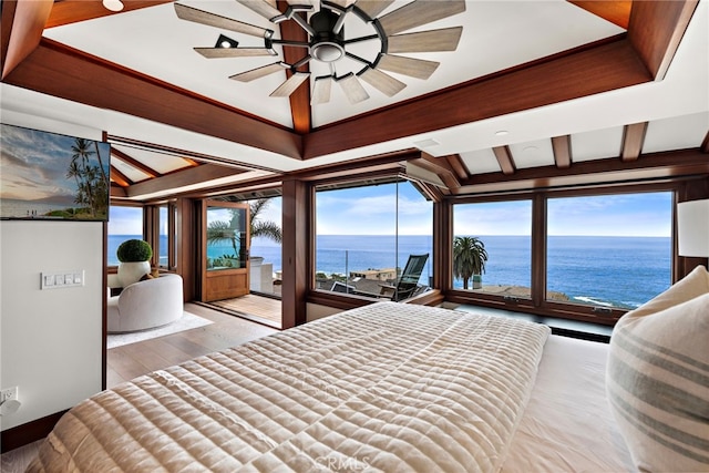 bedroom with a water view, access to exterior, and wood finished floors
