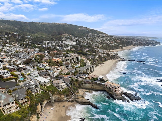 drone / aerial view with a beach view and a water and mountain view