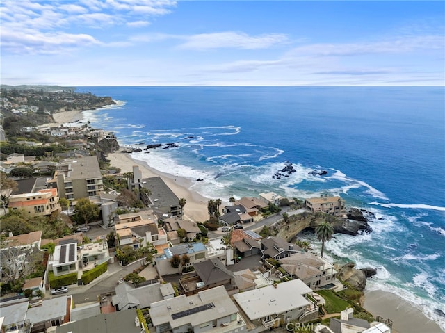 birds eye view of property with a beach view and a water view