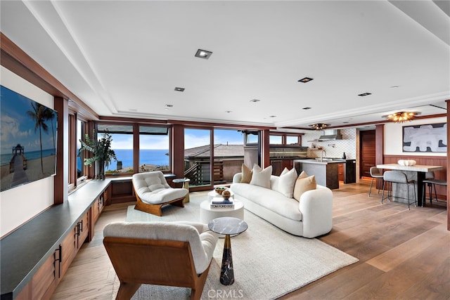 living area with light wood-style floors and a water view