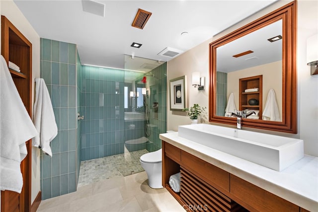 bathroom with visible vents, tile patterned flooring, vanity, toilet, and walk in shower