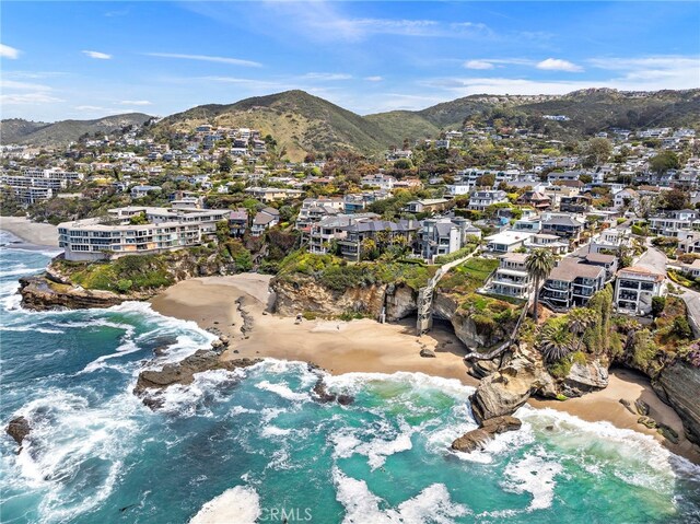 birds eye view of property with a view of the beach and a water and mountain view
