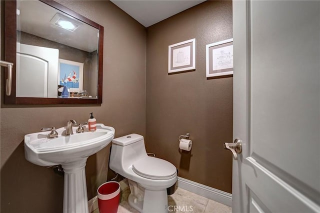 4805 Bellflower Ave Unit 205, North Hollywood, CA 91601 - half bathroom featuring tile patterned flooring, toilet, and baseboards