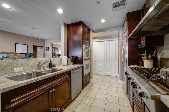 4805 Bellflower Ave Unit 205, North Hollywood, CA 91601 - kitchen with stainless steel appliances, wall chimney range hood, visible vents, a sink, and light tile patterned floors